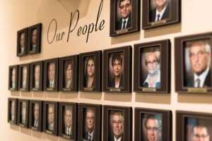 framed staff photos in hallway