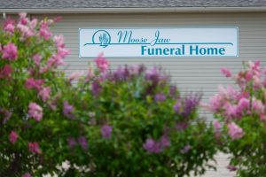 MJFH outdoor sign and garden, moose jaw funeral home, burial services, coffin