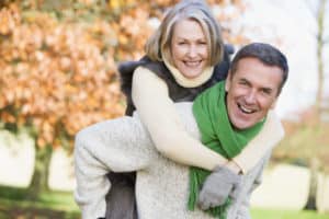 smiling older couple outside in fall